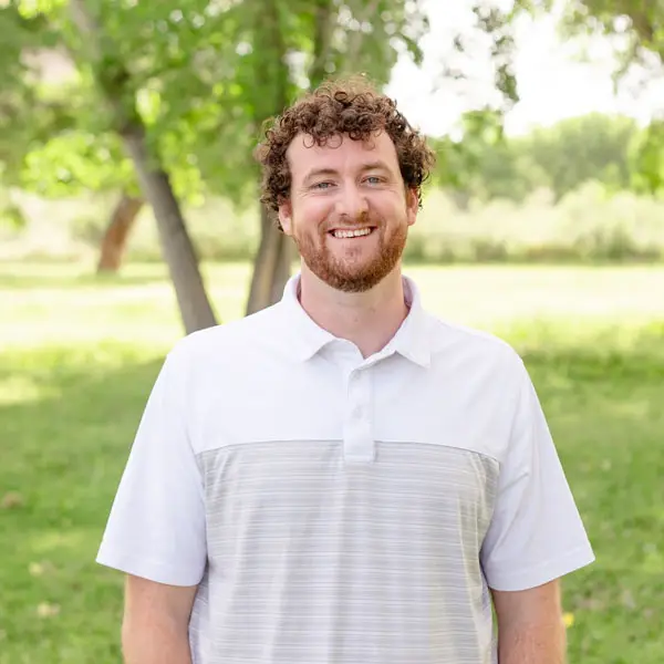 Man in a white polo shirt.